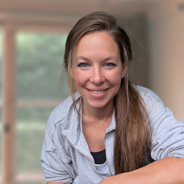Chloé smiling by a window